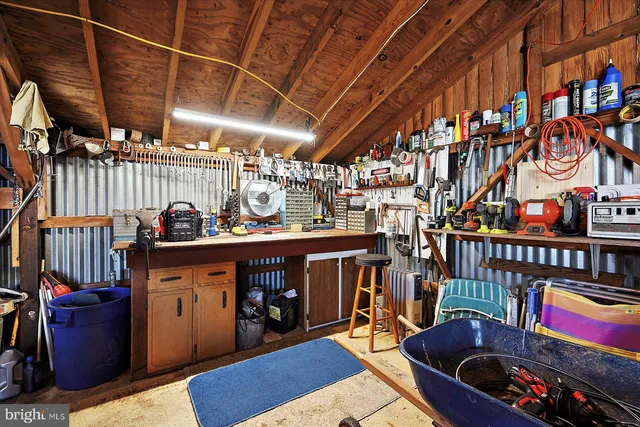 a view of a backyard with sitting area hardwood floor and a fire pit