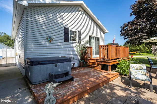 a backyard of a house with plants and outdoor seating