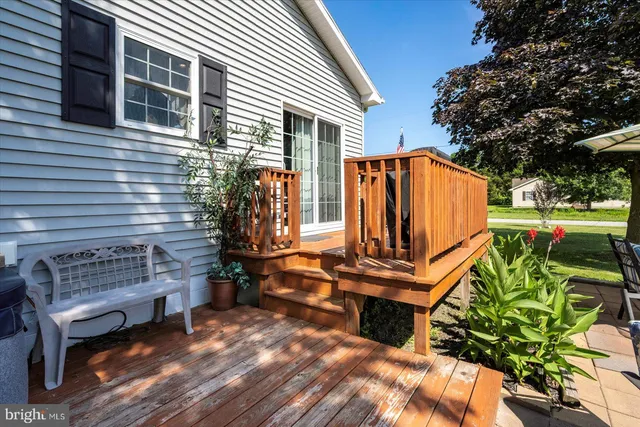 a view of a house with a patio and a yard