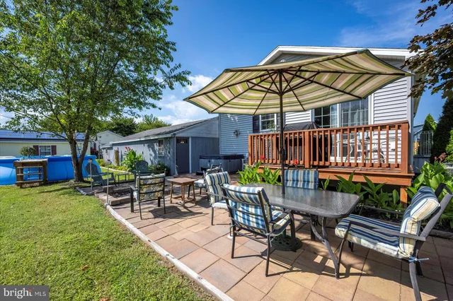 a front view of a house with a yard and potted plants