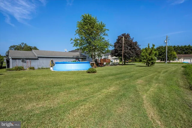 a front view of a house with a garden and garage