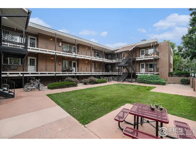 a wooden bench sitting in front of a house