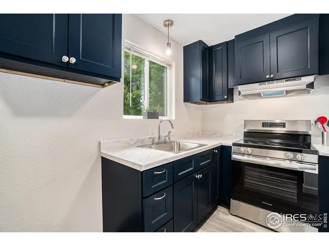 a kitchen with wooden cabinets and a sink