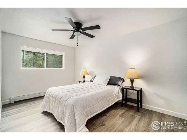 a bedroom with a bed lamp and a window