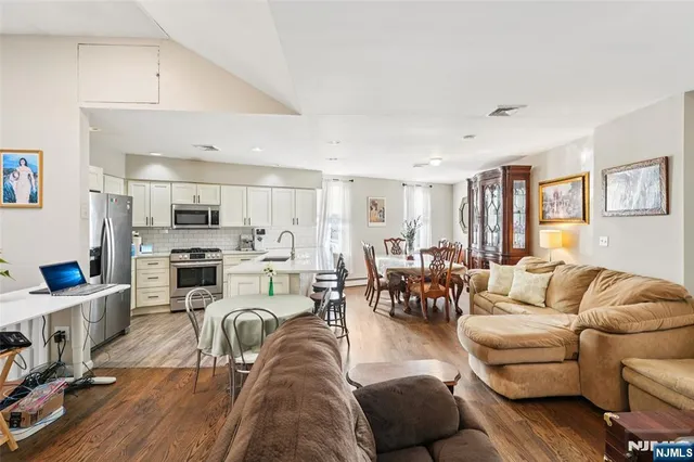 a living room with furniture kitchen view and a couch