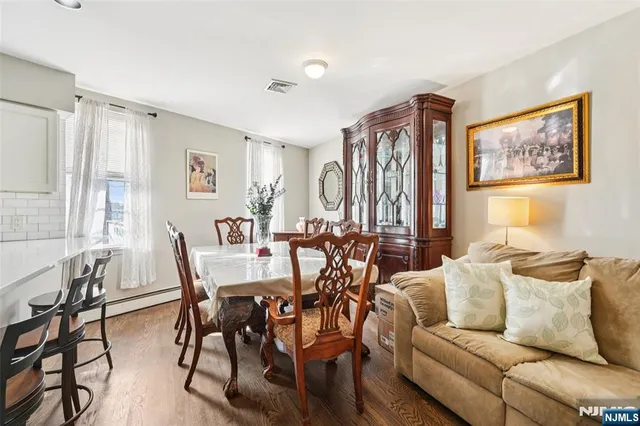 a view of a livingroom and a dining room with furniture window and outside view