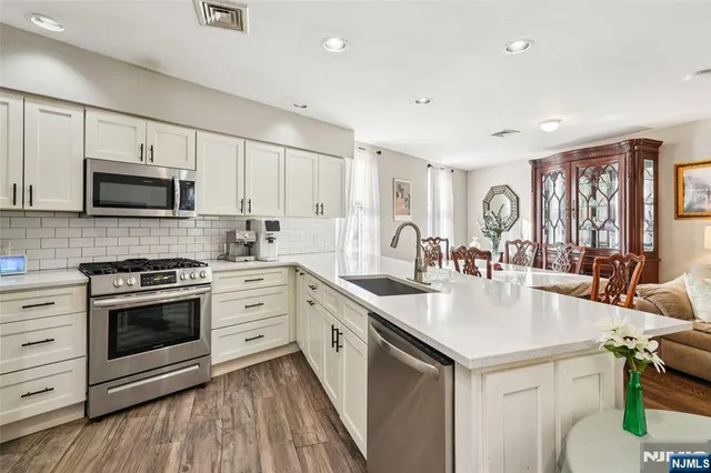 a kitchen with a stove a sink and a microwave