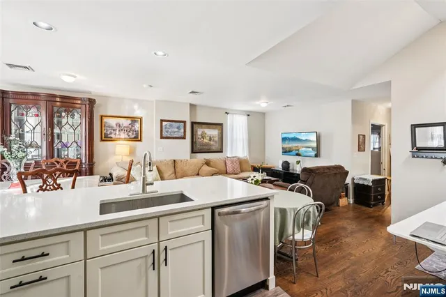 a view of a a dining room with furniture window and wooden floor