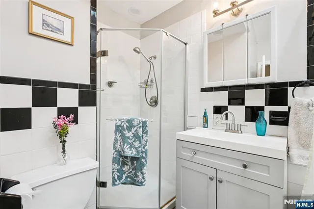 a bathroom with a sink vanity granite tub and shower