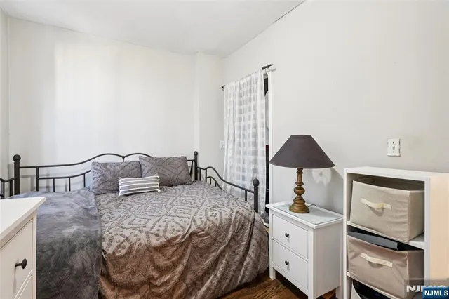 a bedroom with a bed and a chair