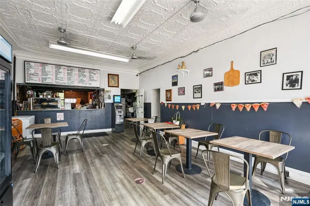 a view of a dining room with furniture and a kitchen