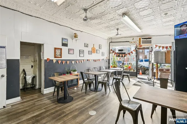 a view of a dining room with furniture and a chandelier