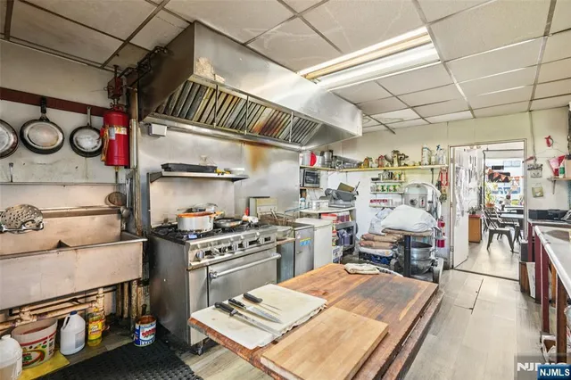 a kitchen with a stove and a table chair