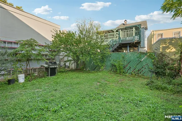 a view of backyard of house with green space