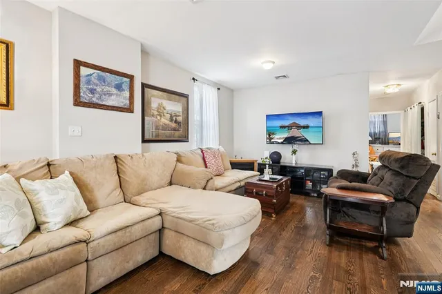 a living room with furniture a couch and wooden floor