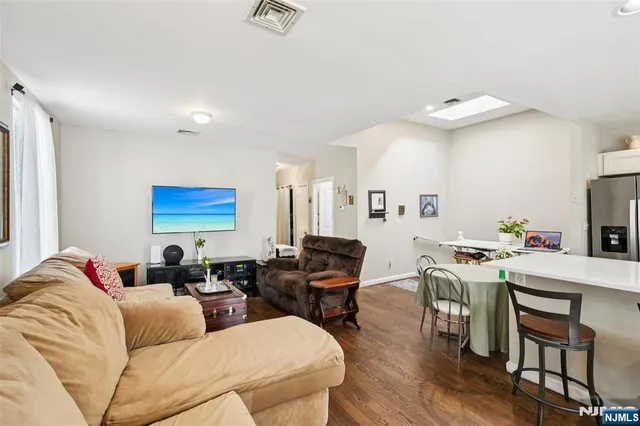 a living room with furniture a dining table and chairs