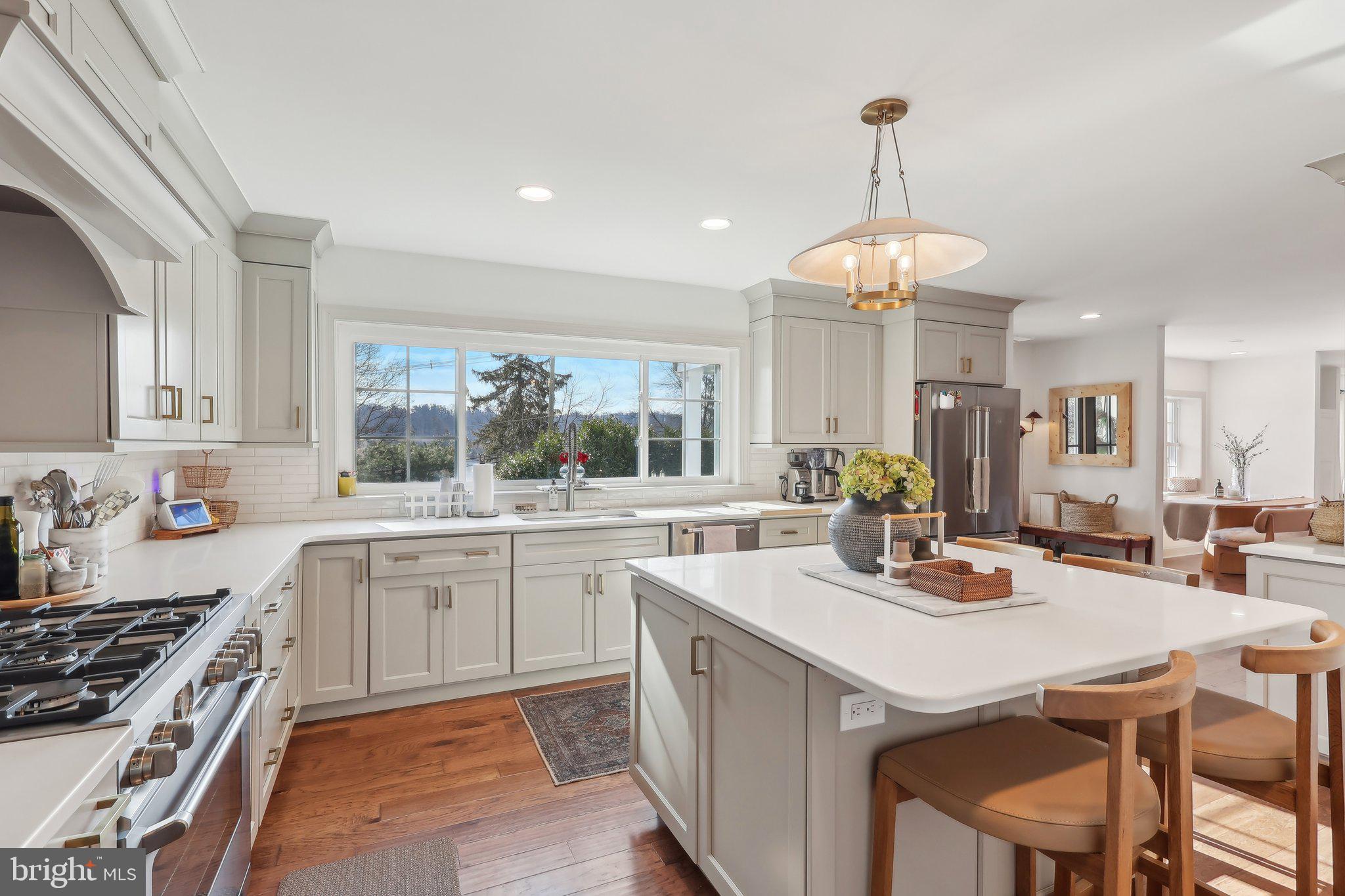 206 Upper Gulph Road Radnor, PA 19087 - Photo 5 of 36 a kitchen with a stove a sink a dining table and chairs