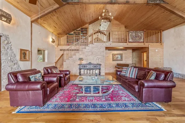 a living room with furniture a rug and a fireplace