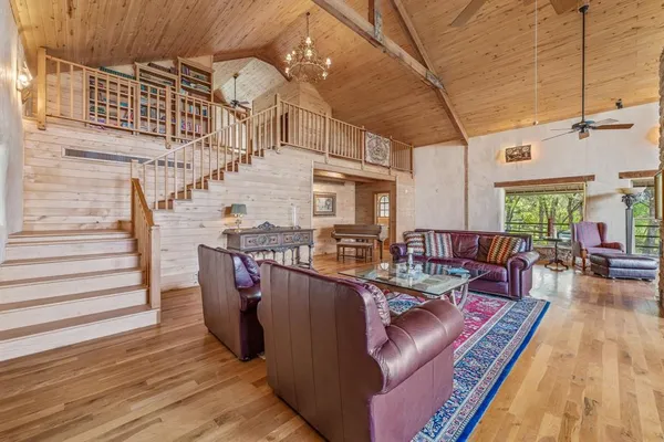 a dining room with furniture window wooden floor and chandelier