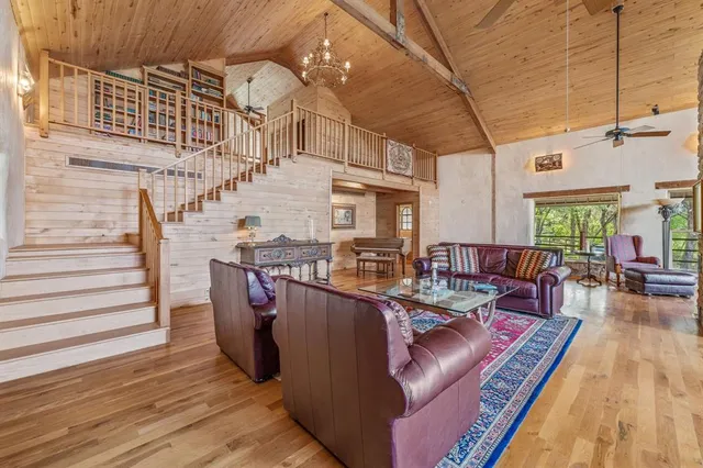a dining room with furniture window wooden floor and chandelier