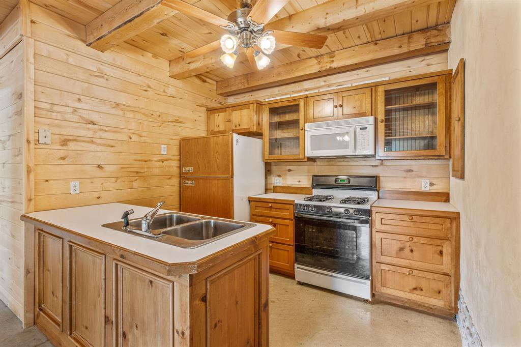 5905 North Us Highway Hamilton, TX 76531 - Photo 23 of 40 a kitchen that has a sink and a stove