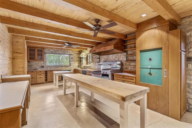 a kitchen with a sink a stove and cabinets