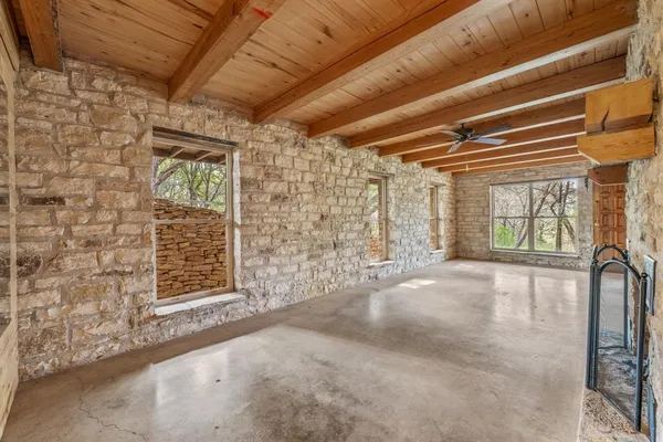 an empty room with fireplace and chandelier