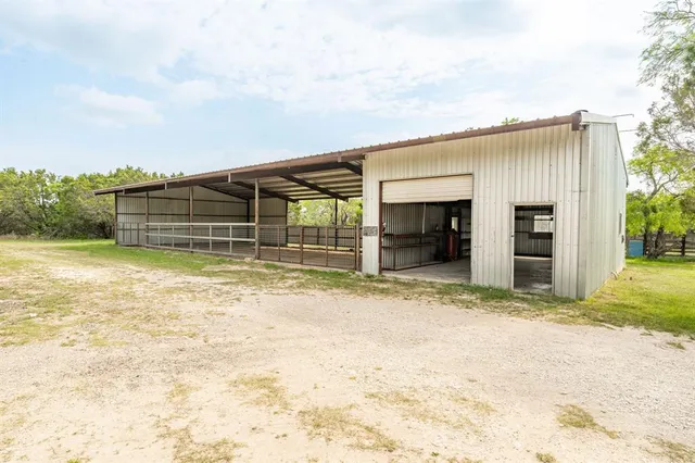 a view of a house with a backyard and a garage