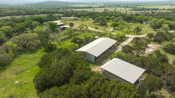 an aerial view of a house with a yard