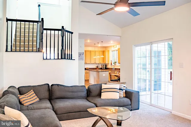a living room with furniture and a floor to ceiling window