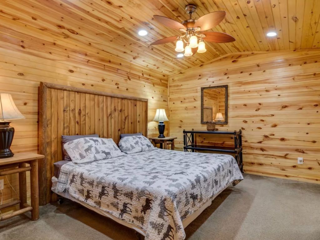 1634 Ridgecrest Drive Sevierville, TN 37876 - Photo 15 of 18 a bedroom with a bed wall painting and a chandelier