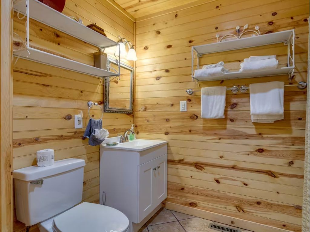 1634 Ridgecrest Drive Sevierville, TN 37876 - Photo 17 of 18 a bathroom with a toilet sink and mirror