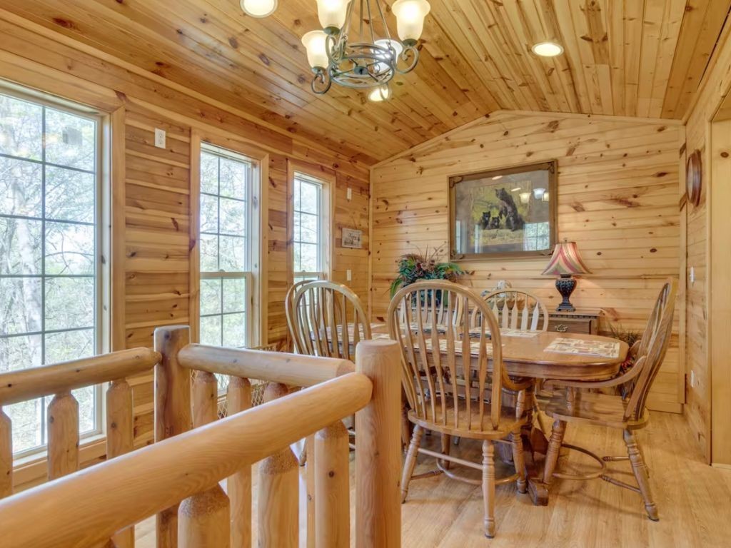 1634 Ridgecrest Drive Sevierville, TN 37876 - Photo 5 of 18 a view of a dining room with furniture a chandelier and large windows