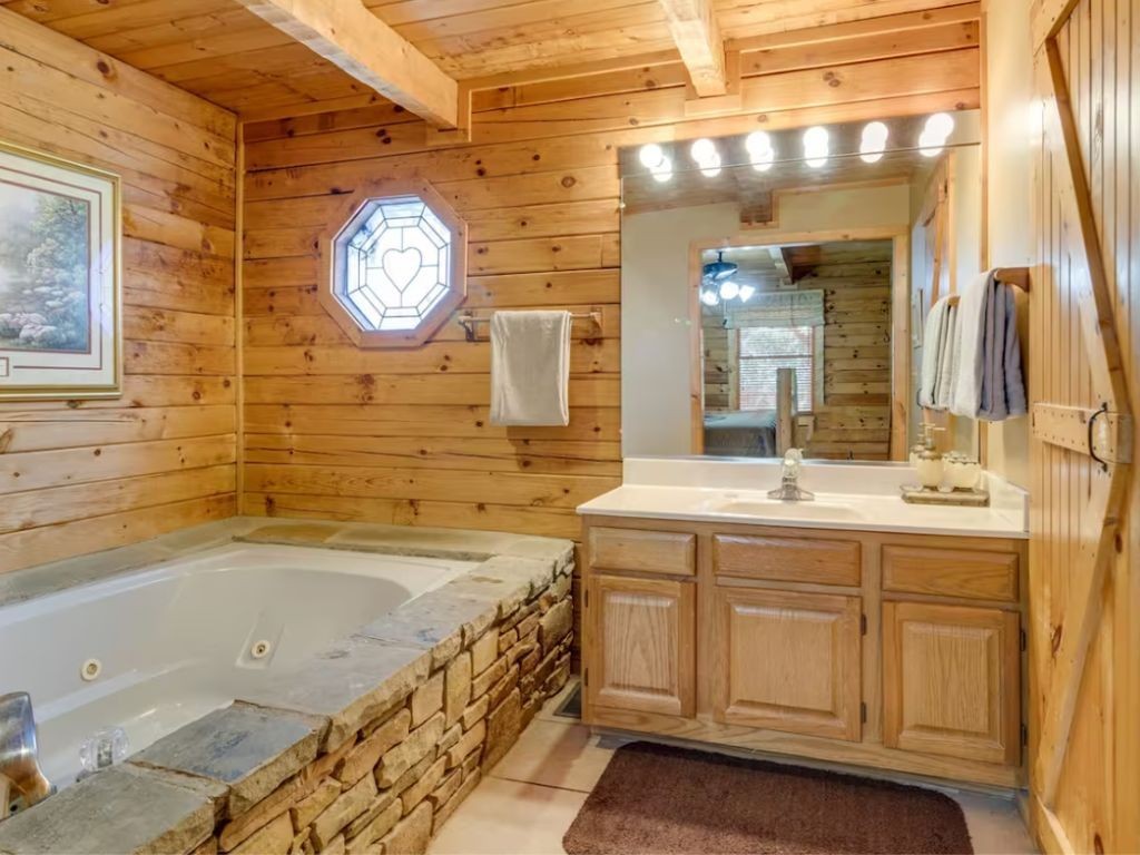 1634 Ridgecrest Drive Sevierville, TN 37876 - Photo 8 of 18 a bathroom with a sink a large mirror and a bathtub