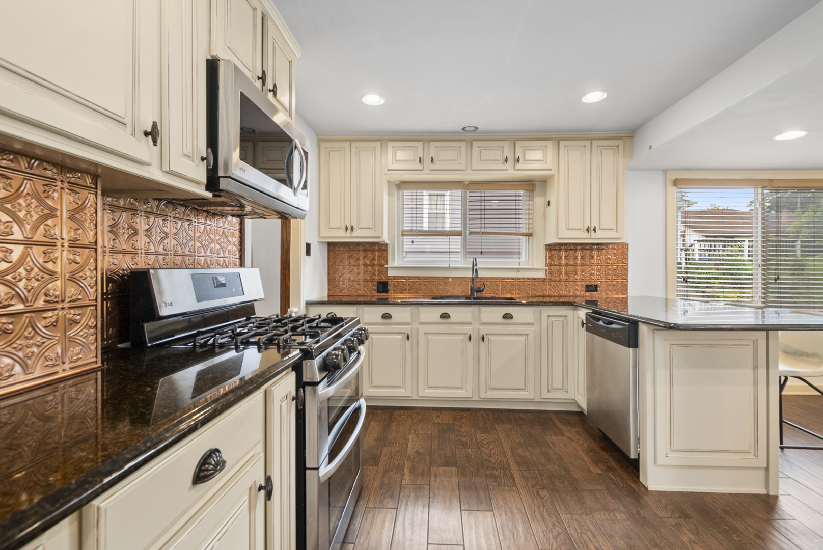714 Walnut Street Lemont, IL 60439 - Photo 12 of 25 a kitchen with stainless steel appliances a stove sink and cabinets