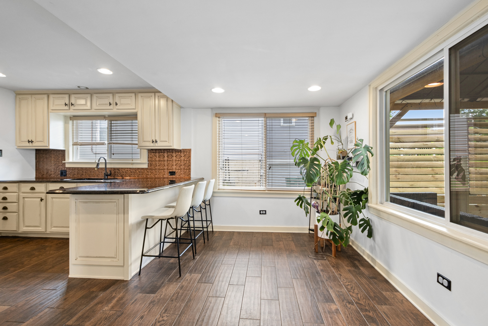 714 Walnut Street Lemont, IL 60439 - Photo 13 of 25 a kitchen with granite countertop white cabinets stainless steel appliances a window and a potted plant