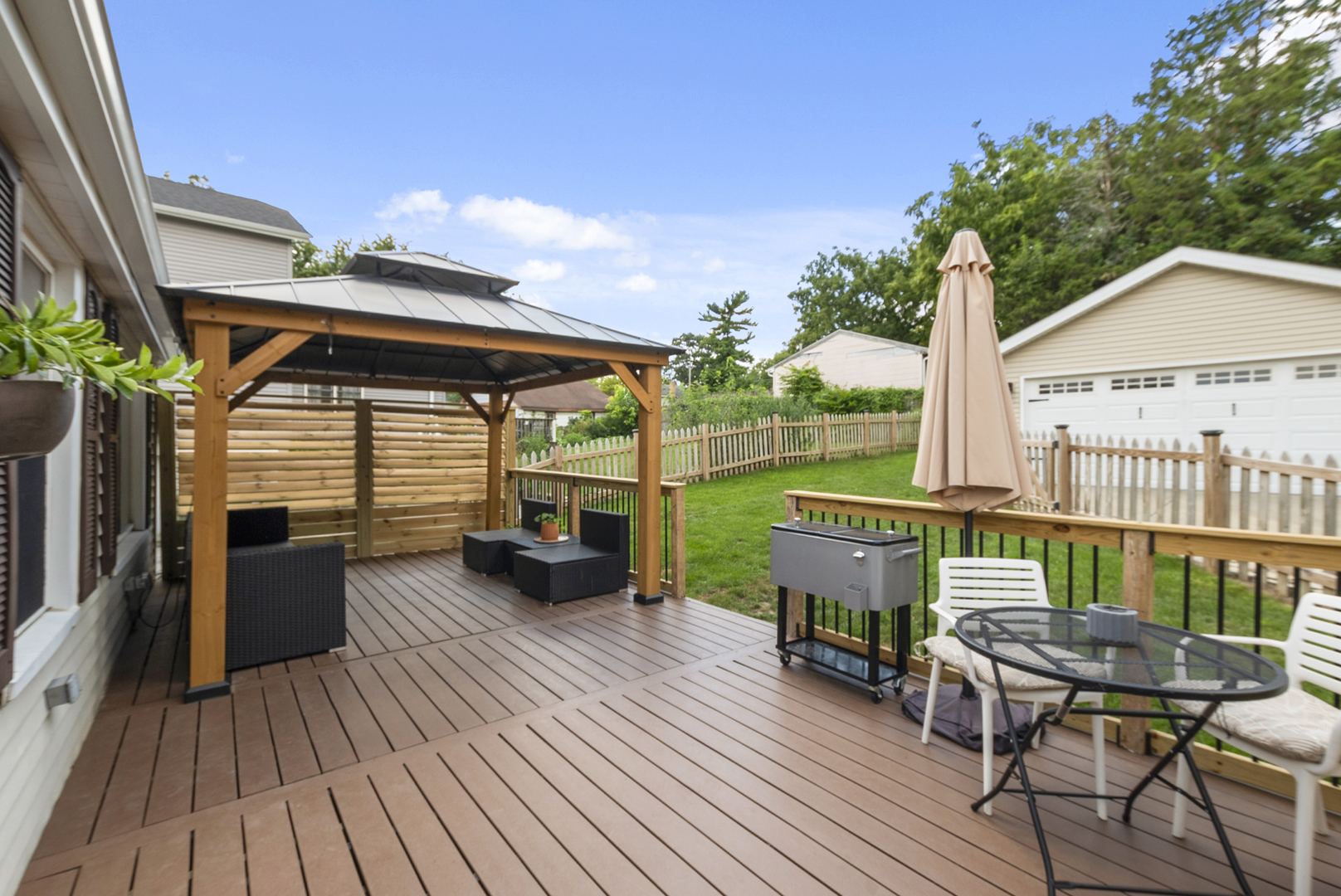 714 Walnut Street Lemont, IL 60439 - Photo 22 of 25 a view of deck with table and chairs a barbeque with wooden floor and fence
