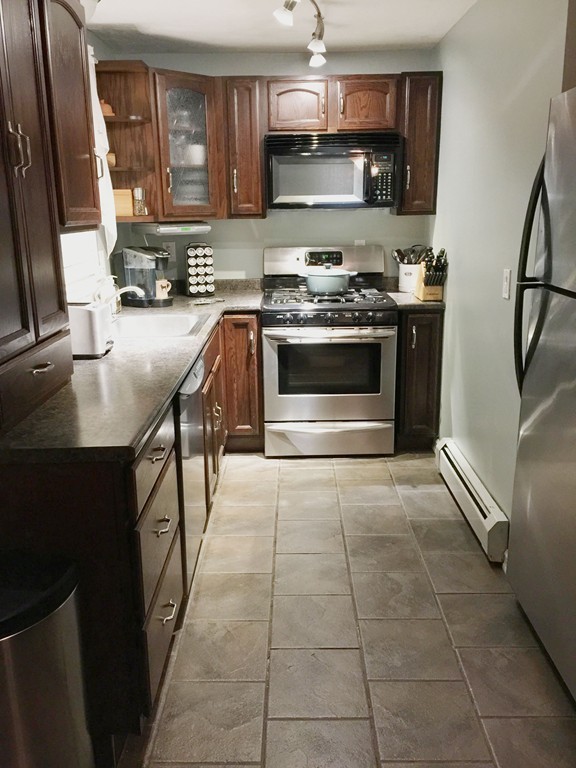 30 Standish Road, Unit 1 & 2 Bourne, MA 02562 - Photo 3 of 30 a kitchen with stainless steel appliances a stove a sink and a microwave