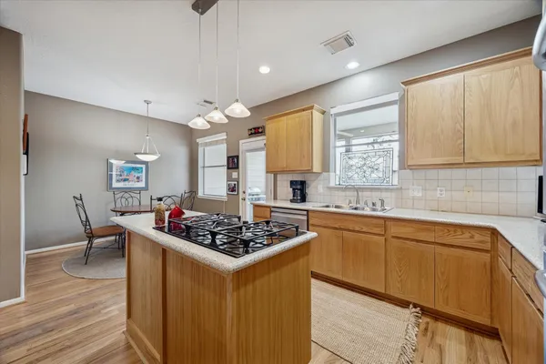 a kitchen with a sink and chairs