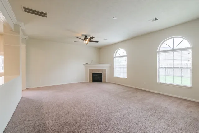 a view of a livingroom with a ceiling fan and window