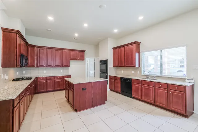 a kitchen with granite countertop a sink and a window