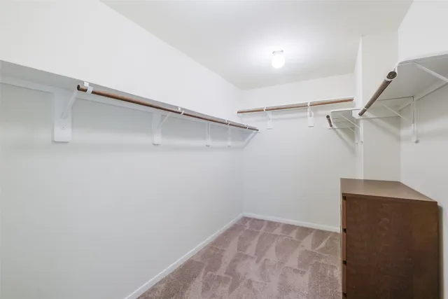a view of an empty room with a ceiling fan