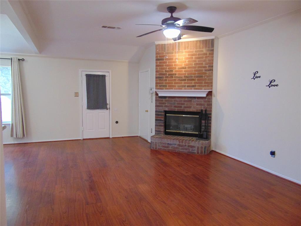 1425 Sunny Meadow Road Lancaster, TX 75134 - Photo 15 of 22 a view of empty room with wooden floor and fireplace