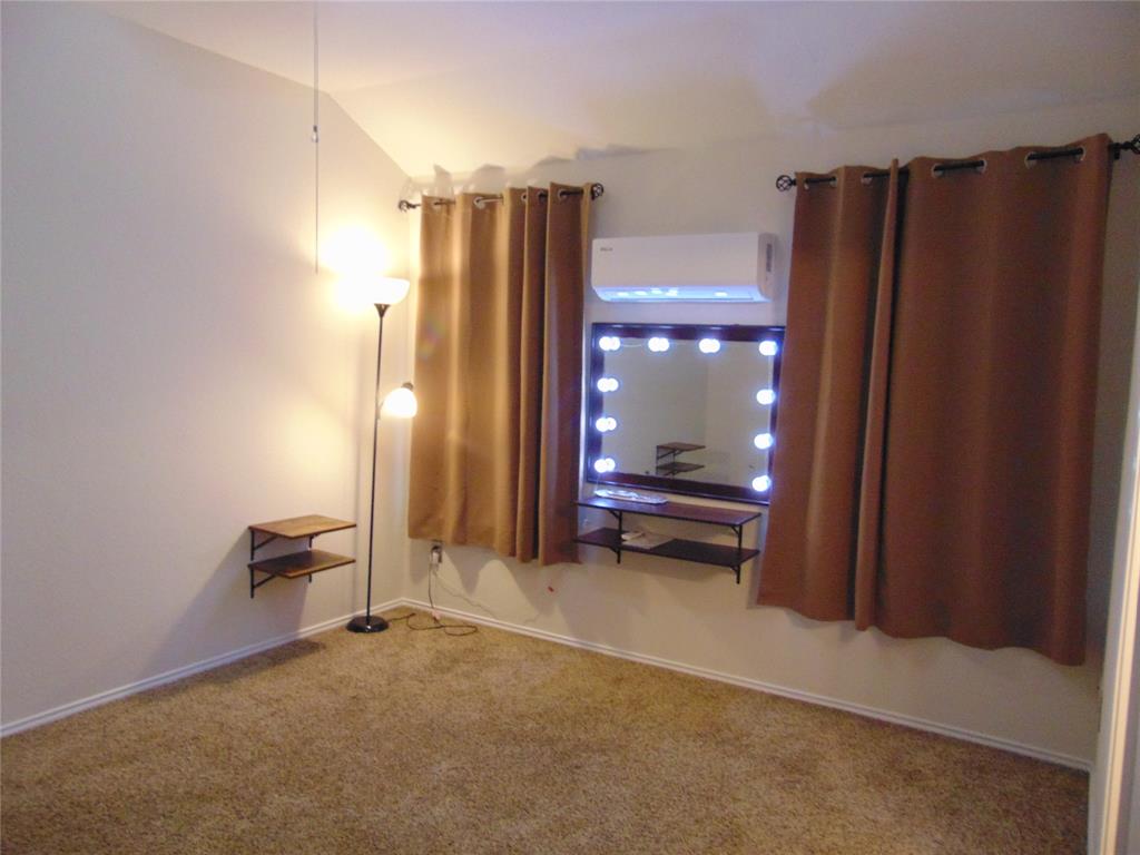 1425 Sunny Meadow Road Lancaster, TX 75134 - Photo 17 of 22 a view of a hallway with wooden floor and a bathroom