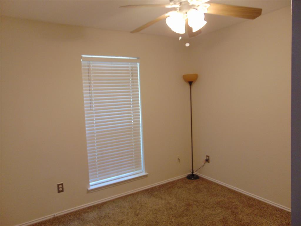 1425 Sunny Meadow Road Lancaster, TX 75134 - Photo 19 of 22 a view of a room with a mirror and a fan
