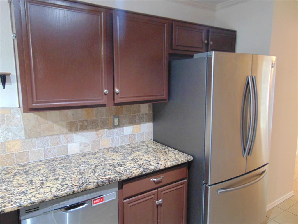 1425 Sunny Meadow Road Lancaster, TX 75134 - Photo 10 of 22 a kitchen with granite countertop cabinets and refrigerator