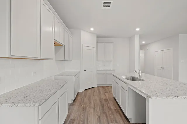 a spacious bathroom with a granite countertop sink