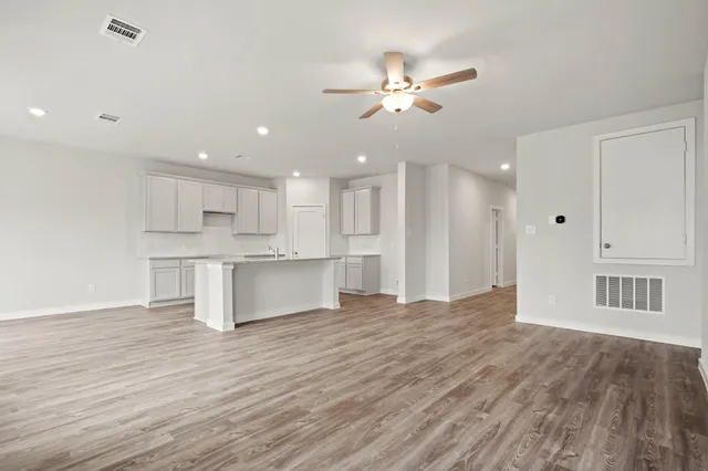 a view of kitchen and kitchen with sink oven cabinets
