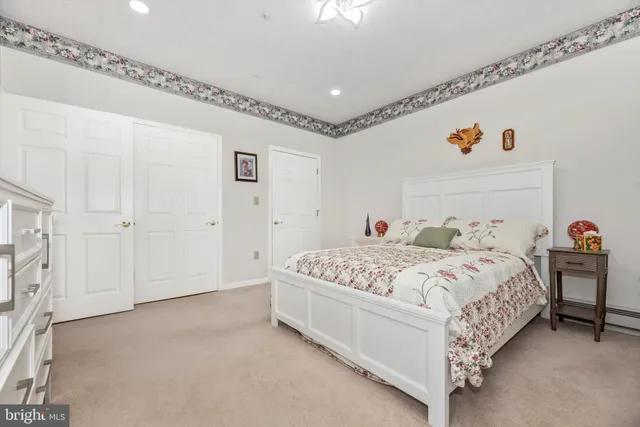 a view of a kitchen with white cabinets and wooden floor