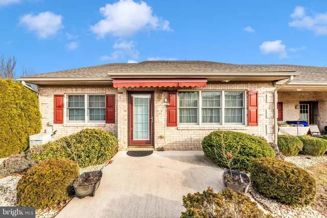 a bedroom with furniture and a large window